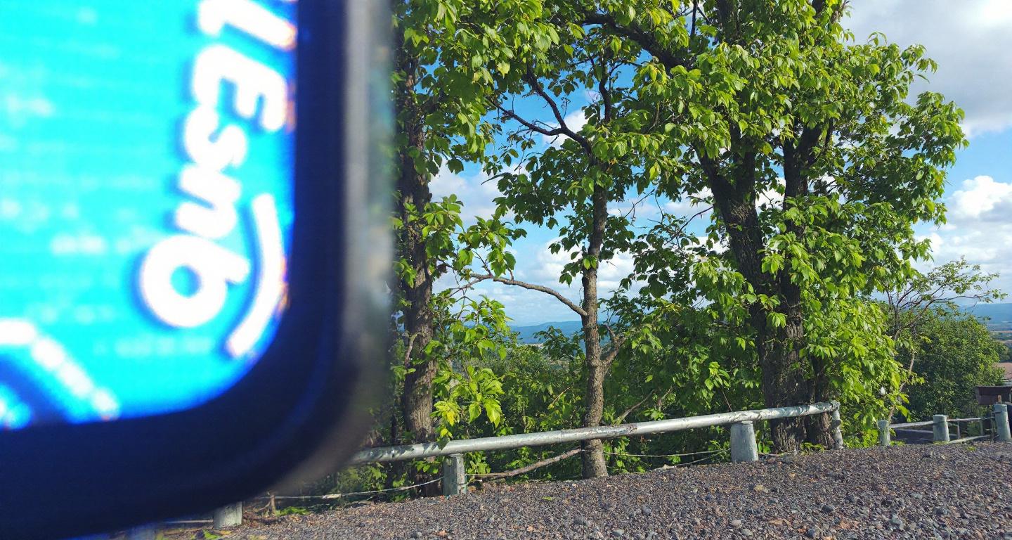 Professional computer technician examining laptop components at organized repair workstation